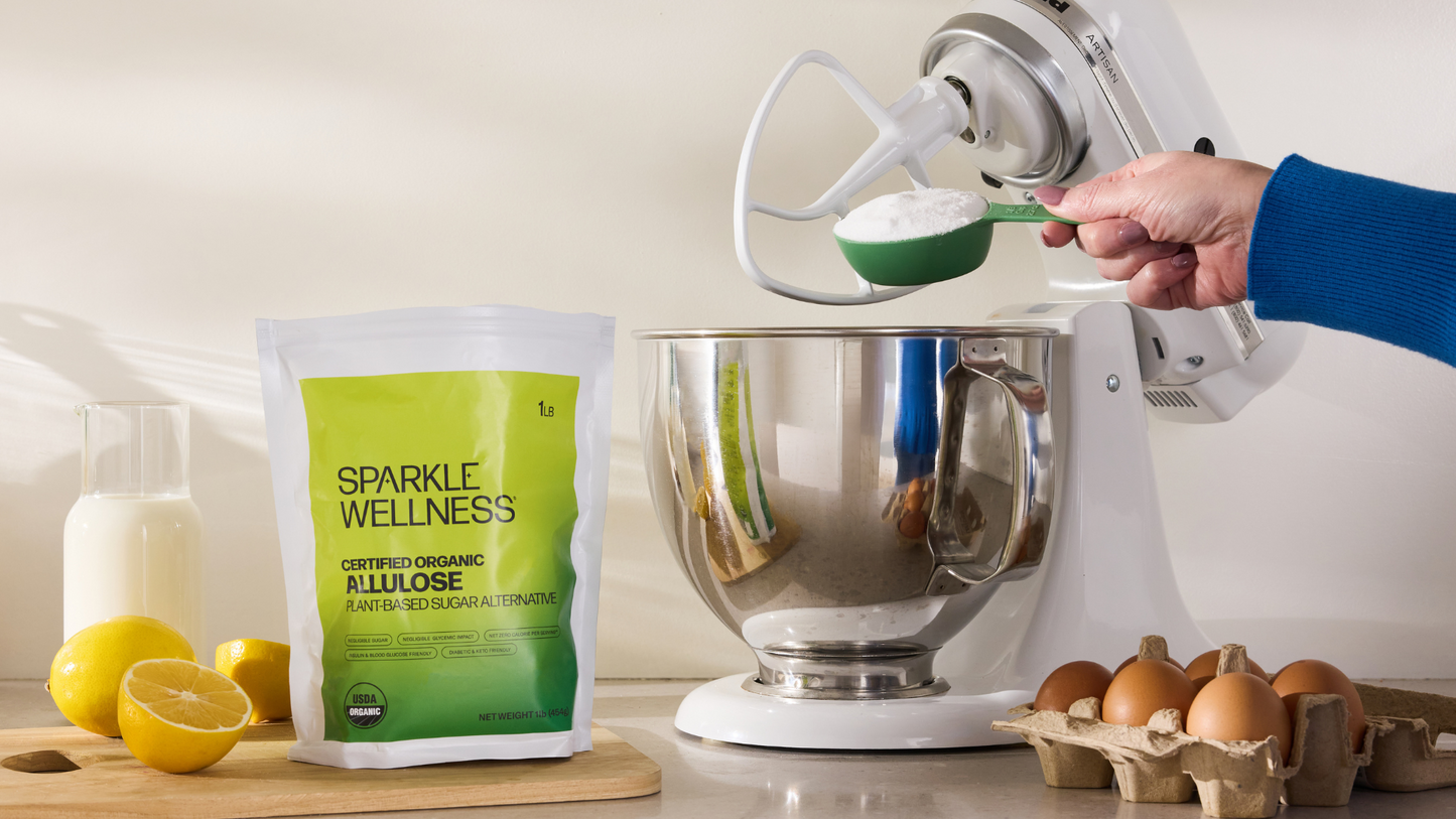 Baking equipment and ingredients on a counter, including a bag of Sparkle Wellness Organic Allulose.